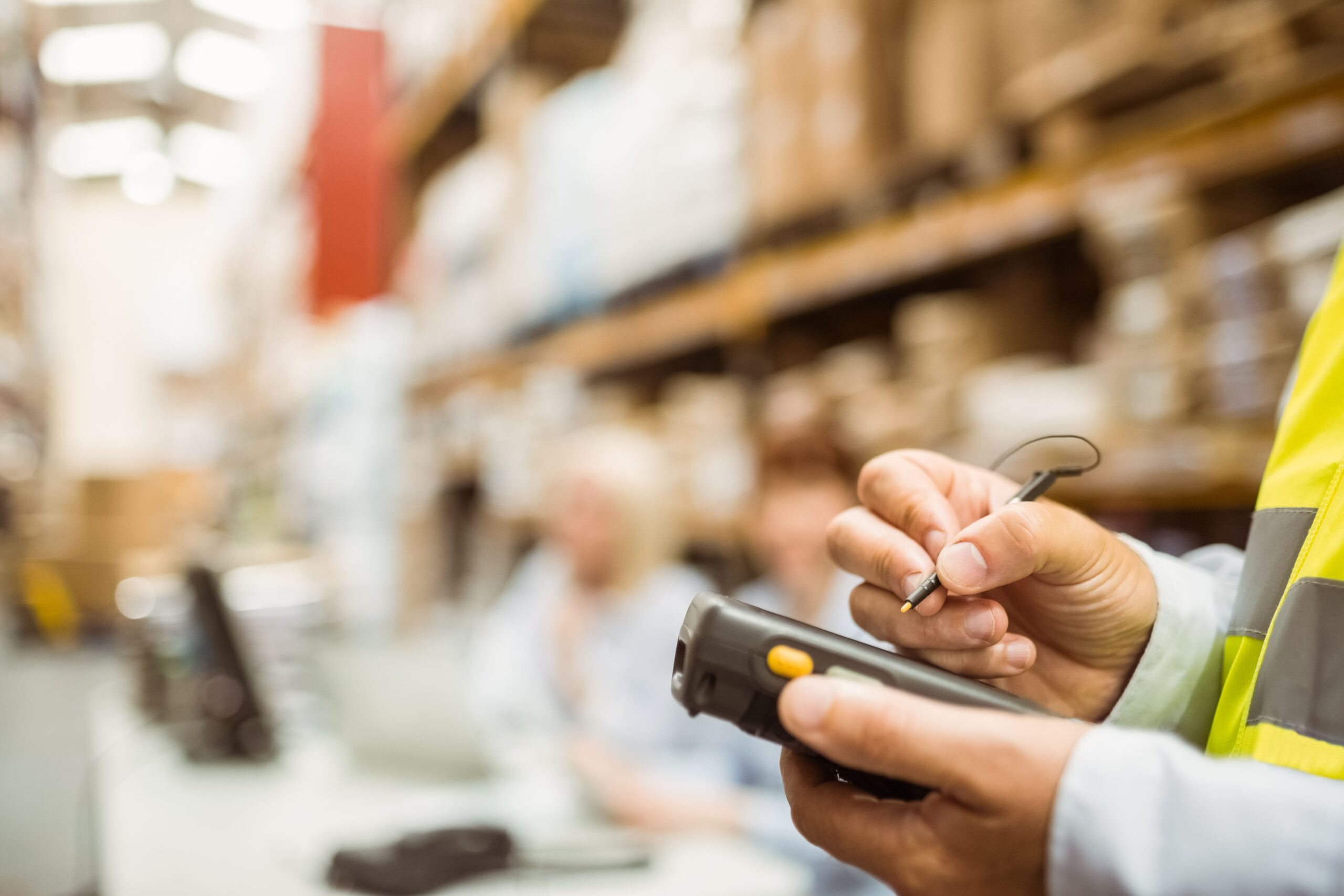A warehouse employee checks off information in his handheld device.
