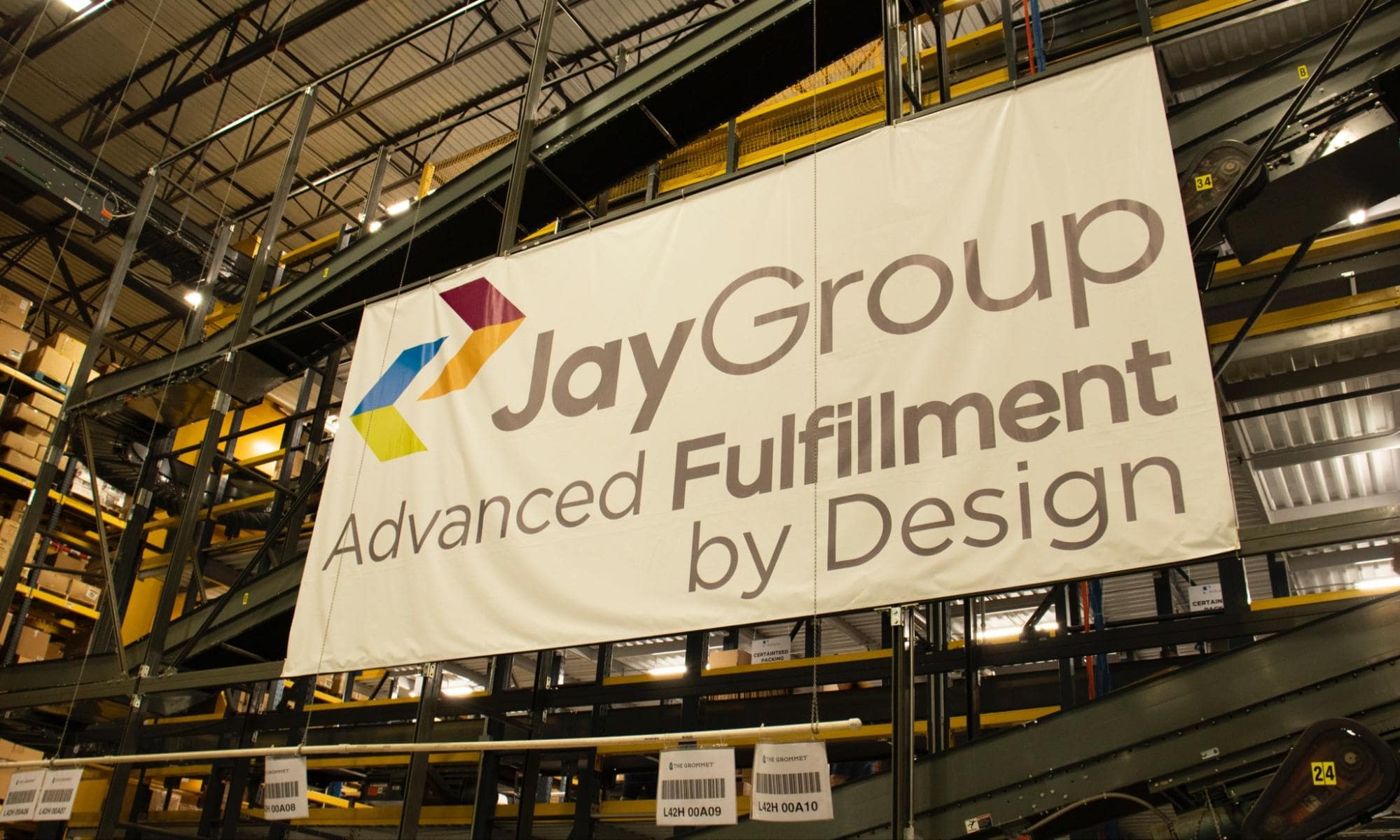 A sign displaying Jay Group Fulfillment by Design. Jay Group is a perfect 3PL Shopify Integration fulfillment partner.