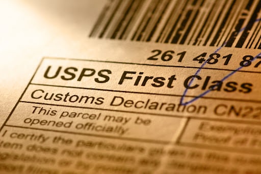 A USPS first class shipping label with a customs declaration underneath it.